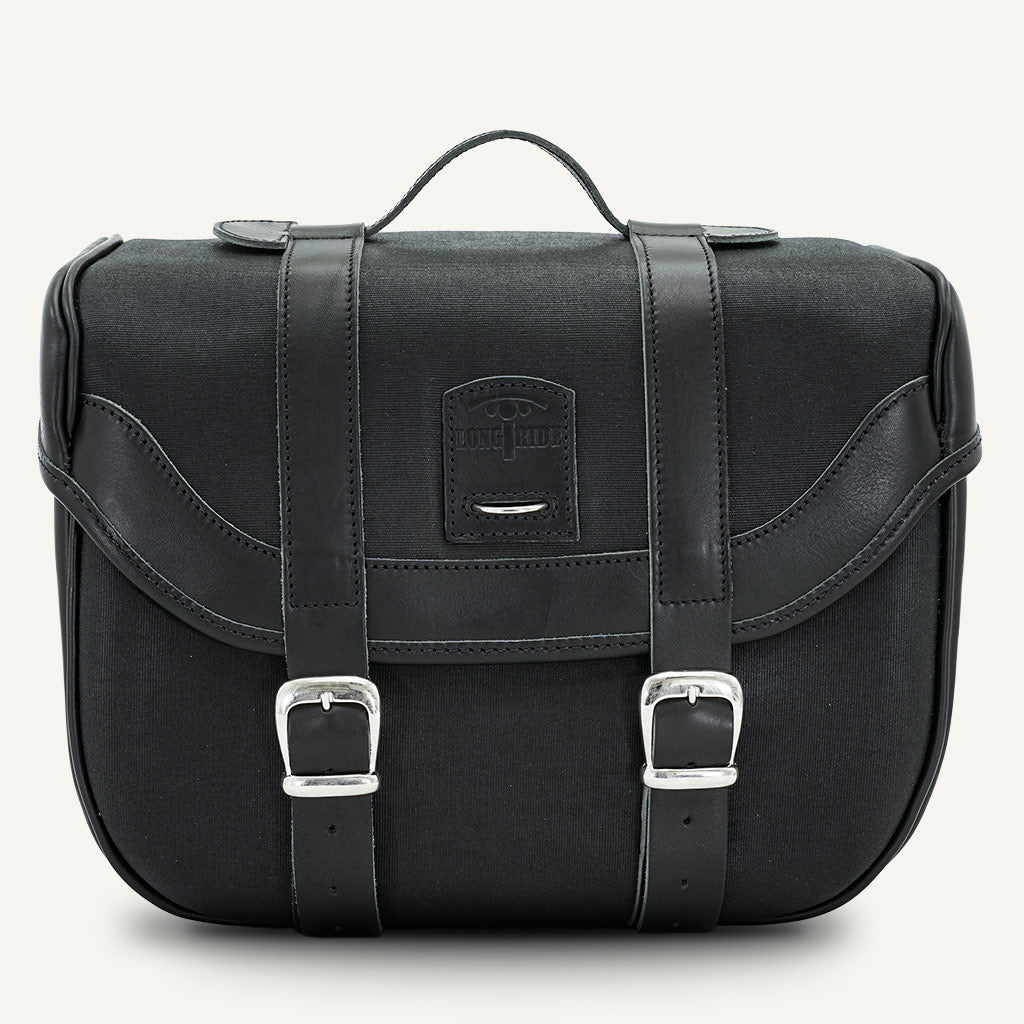 Black waxed cotton hard pannier moto.