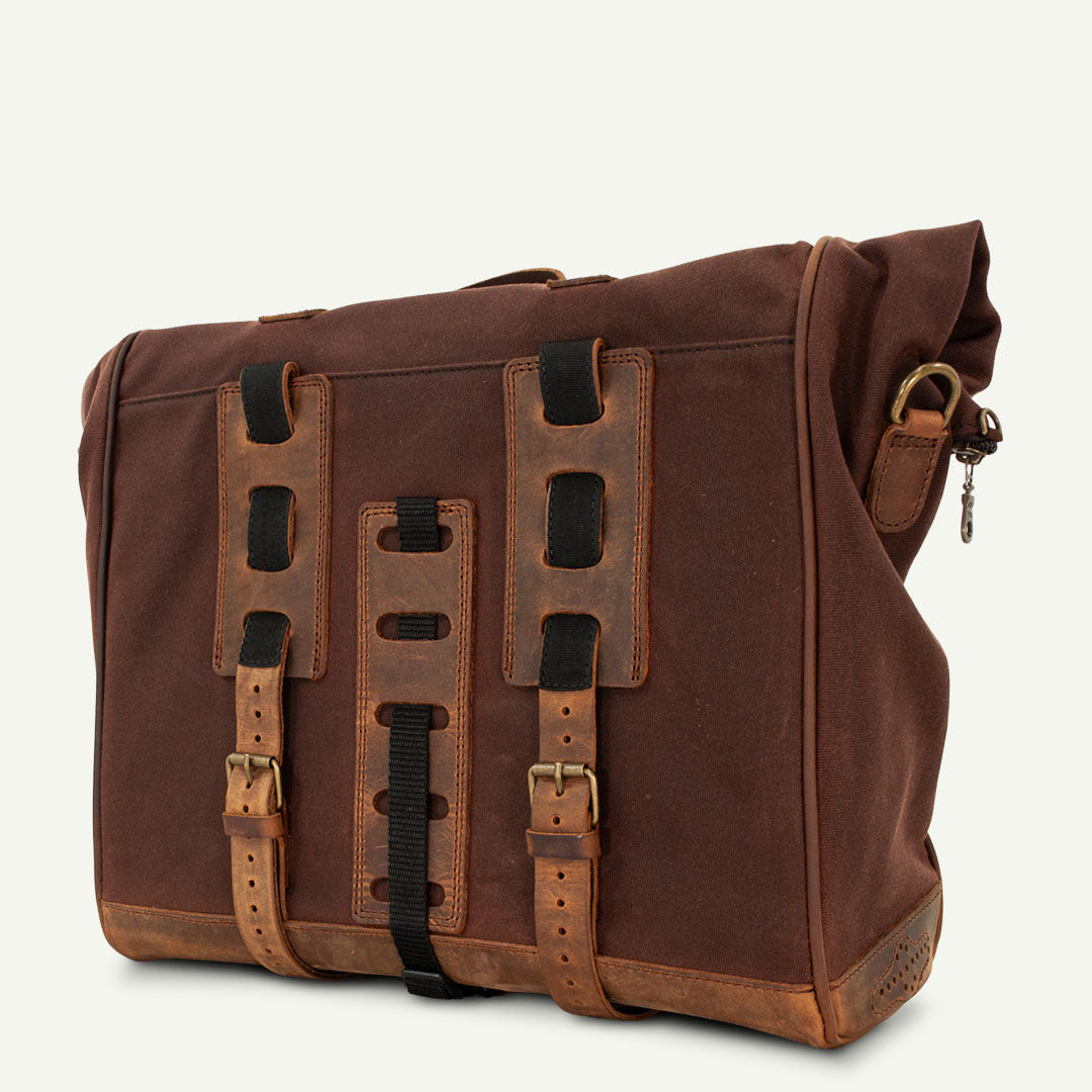Large soft saddlebag for retro motorcycle made from brown waxed cotton and leather.